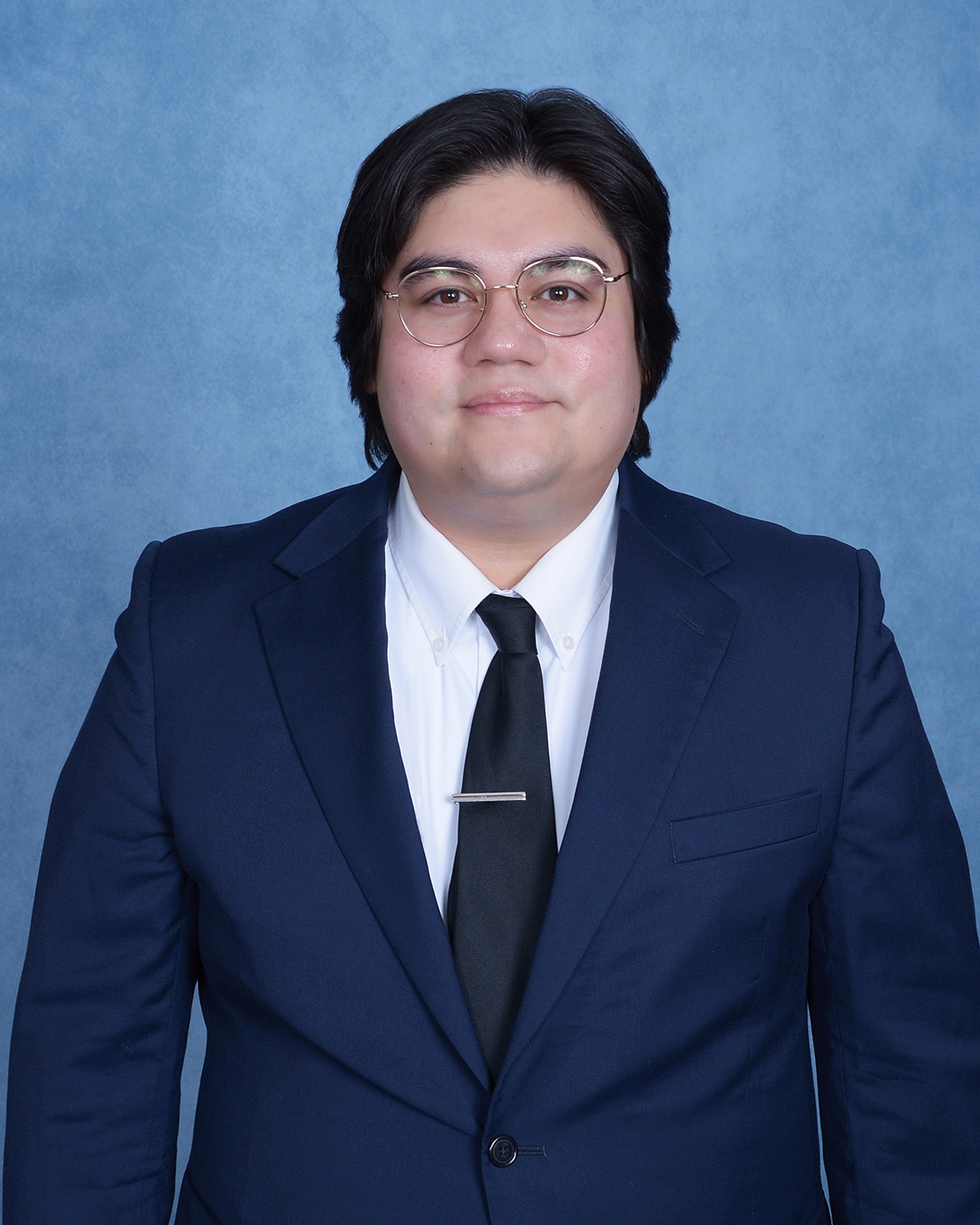 Professional headshot of Benjamin Gallegos, mid-waist up.